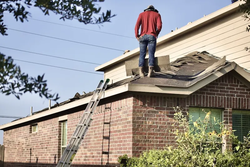 Professional roofer working on a residential roof in Bentwood Grove